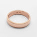 Low dome 14kt rose gold wedding band with comfort fit interior on white background