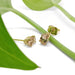 Malaya garnet and 14kt yellow gold stud earrings styled with green leaves