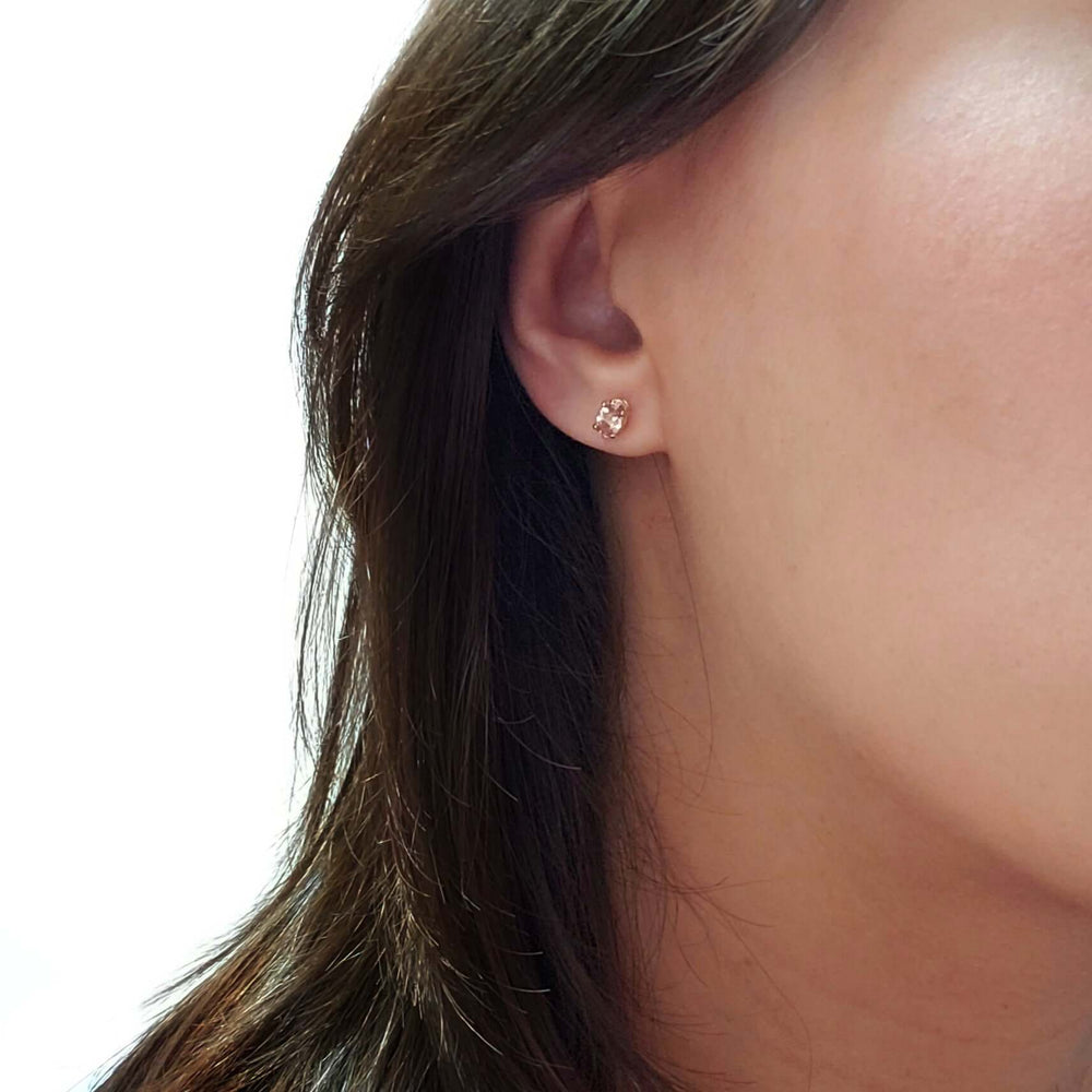 Malaya garnet stud earring in 14kt yellow gold shown on ear