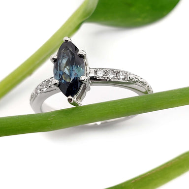 Marquise cut teal Australian sapphire and diamond engagement ring in white gold with engraved band
