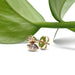 14kt yellow gold marquise diamond bezel stud earrings shown with a green leaf