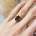 Marquise green sapphire and diamond ring in white gold shown on hand