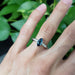 Marquise teal Australian sapphire and diamond ring in white gold, shown on hand
