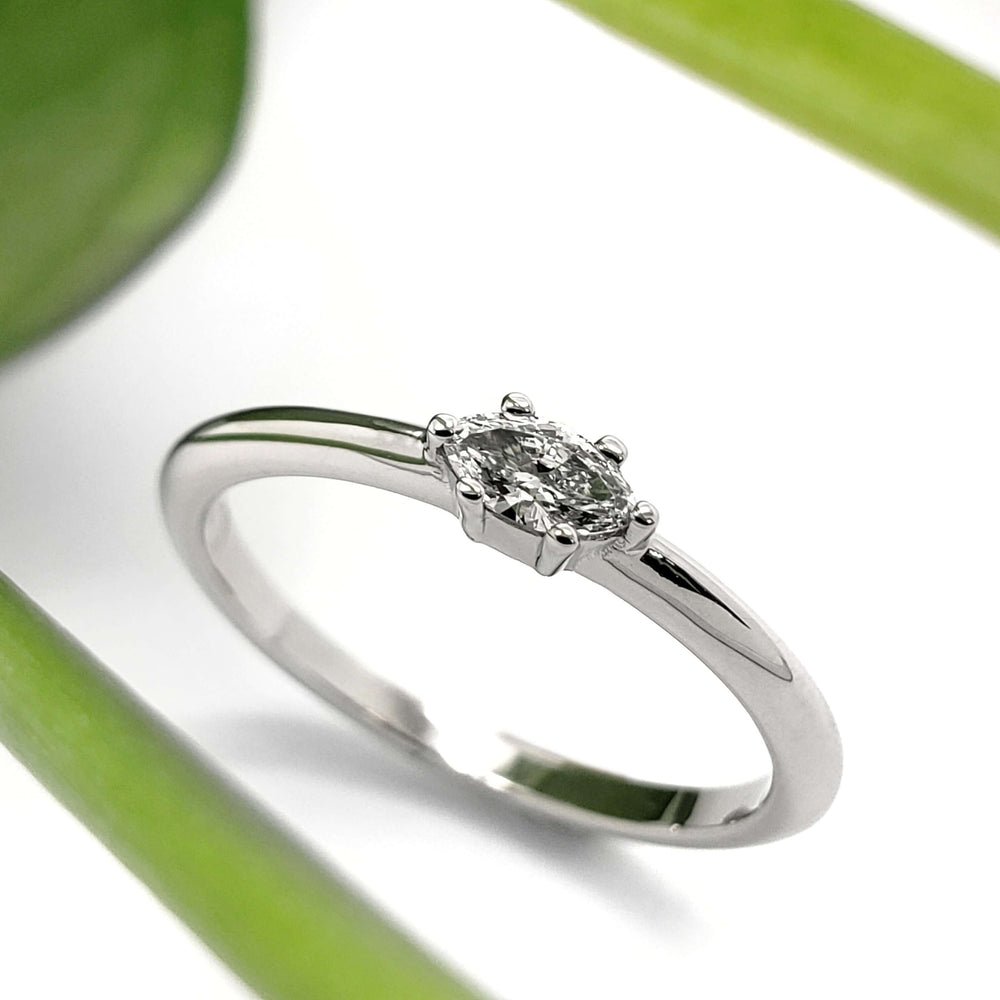 Minimalist white gold marquise lab diamond engagement ring with plant accent