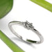 Minimalist white gold marquise lab diamond engagement ring with plant accent