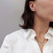 Model wearing 14kt white gold lab diamond stud earrings and a pendant necklace