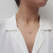 Model wearing 14kt yellow gold necklace with bezel-set rose cut moissanite