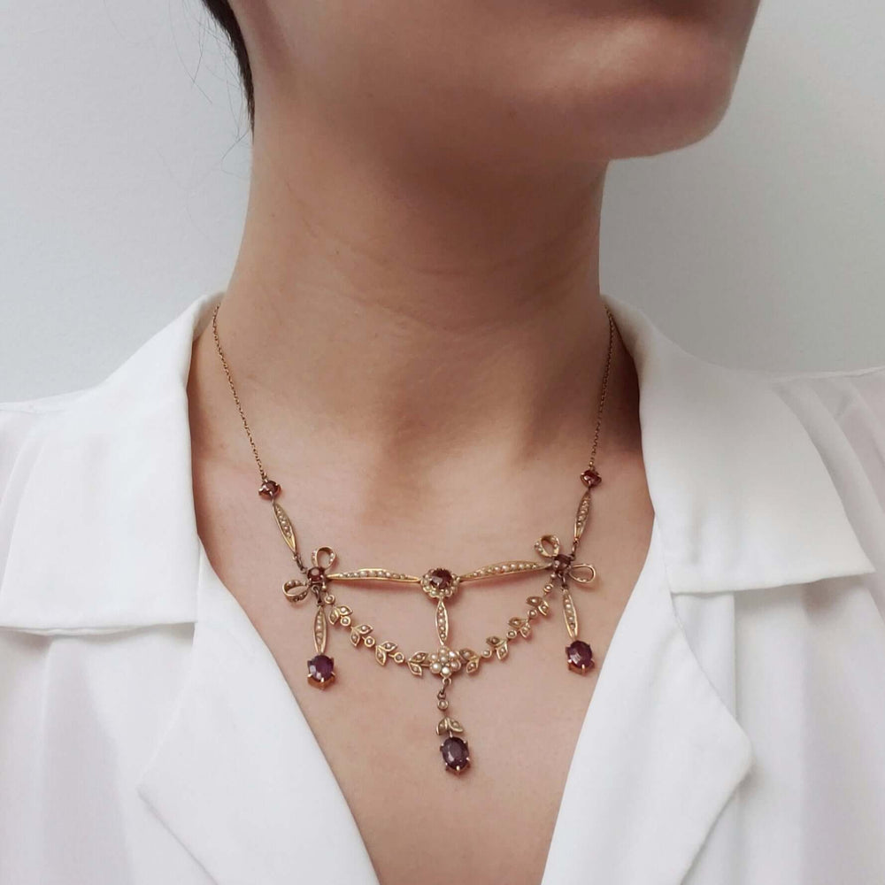 Antique amethyst and pearl lavaliere necklace in 14kt yellow gold worn on a model