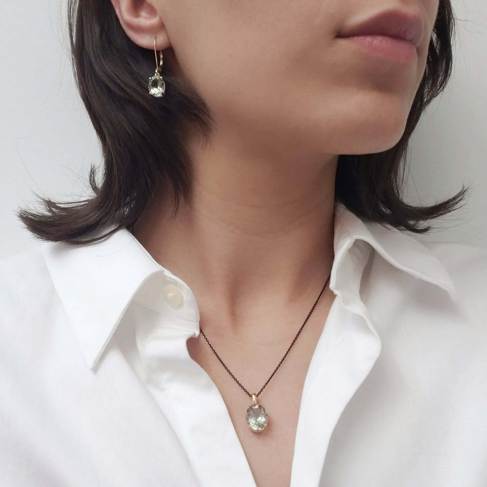 Model wearing prasiolite pendant and matching earring, 14kt yellow gold