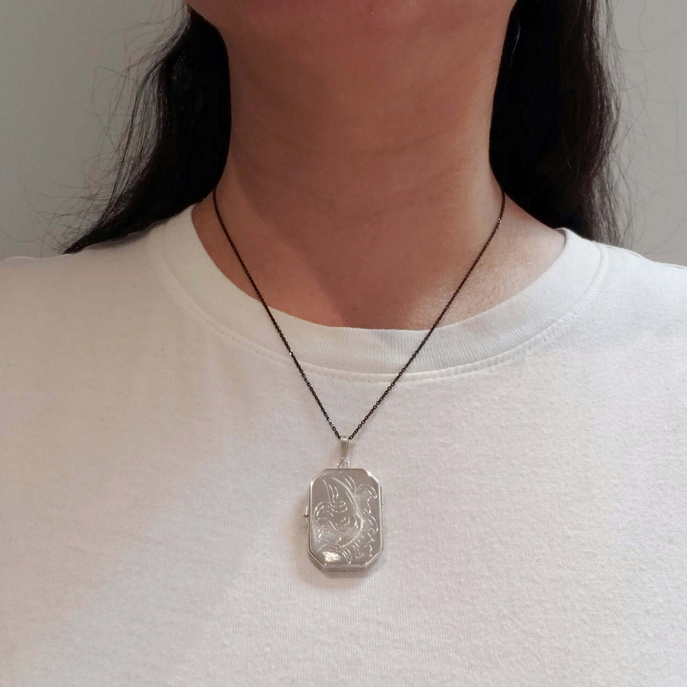 Model wearing vintage sterling silver engraved locket necklace