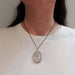 Model wearing vintage sterling silver engraved locket necklace