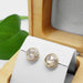 Rose cut moissanite studs in 14kt yellow gold displayed in a cedar jewellery box