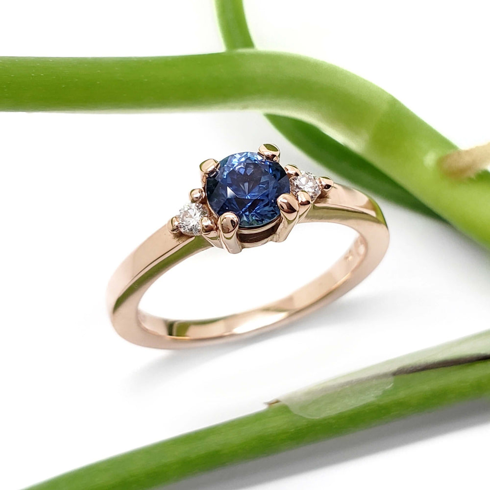 Montana sapphire and Canadian diamond engagement ring in rose gold, styled with green stem