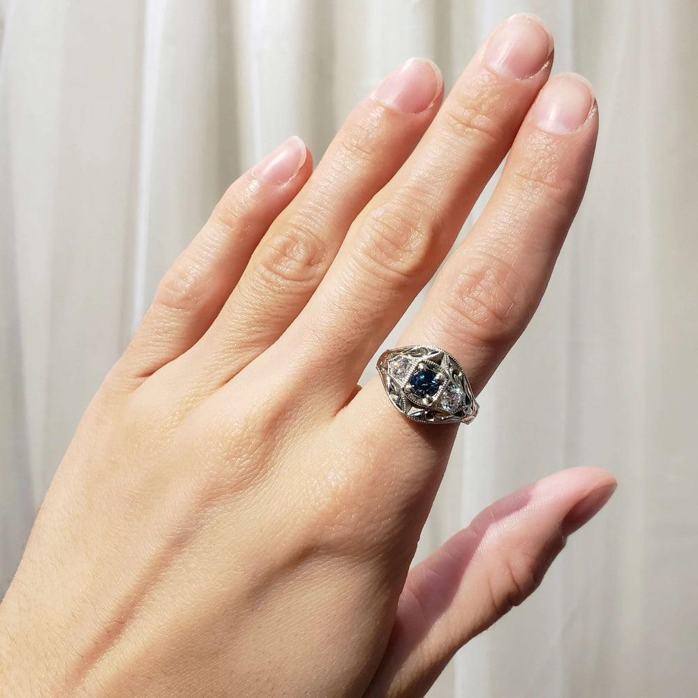 Montana sapphire and Canadian diamond white gold ring worn on hand, full view