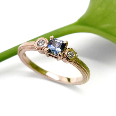Montana sapphire and diamond engagement ring in rose gold with millgrain detail