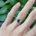 Montana sapphire and diamond engagement ring in white gold, stacked with plain band, on hand