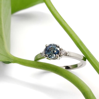 Montana sapphire and diamond engagement ring in white gold, styled with green leaf
