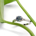 Montana sapphire and diamond engagement ring in white gold, styled with green leaf