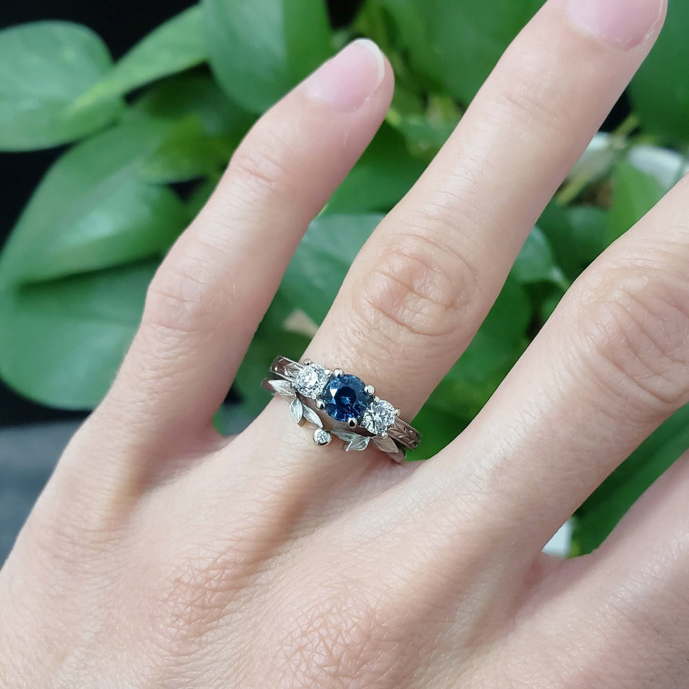 Montana sapphire and diamond ring in white gold, stacked with leaf band, on hand
