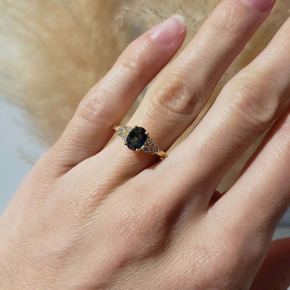 14kt yellow gold Montana sapphire and diamond ring shown on a hand