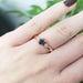 14kt rose gold Montana sapphire and diamond ring worn on a hand