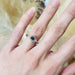 Montana sapphire and diamond 14k white gold ring worn on a hand