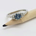 Blue Montana sapphire and diamond ring in white gold shown on a pencil