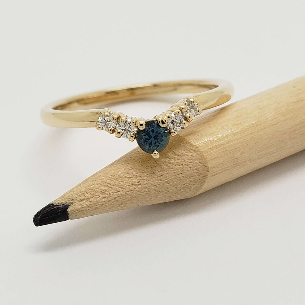 Montana sapphire and diamond yellow gold ring shown with pencil for scale
