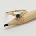 Montana sapphire and diamond yellow gold ring shown with pencil for scale