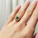 Montana sapphire and diamond yellow gold ring worn on a hand