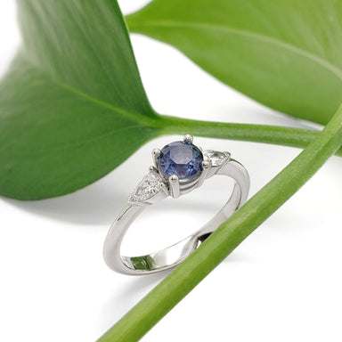 Montana sapphire and lab diamond engagement ring in white gold, displayed on a leaf