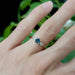 14kt rose gold Montana sapphire and lab diamond ring worn on a hand