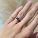Montana sapphire and lab diamond engagement ring in white gold shown on a hand