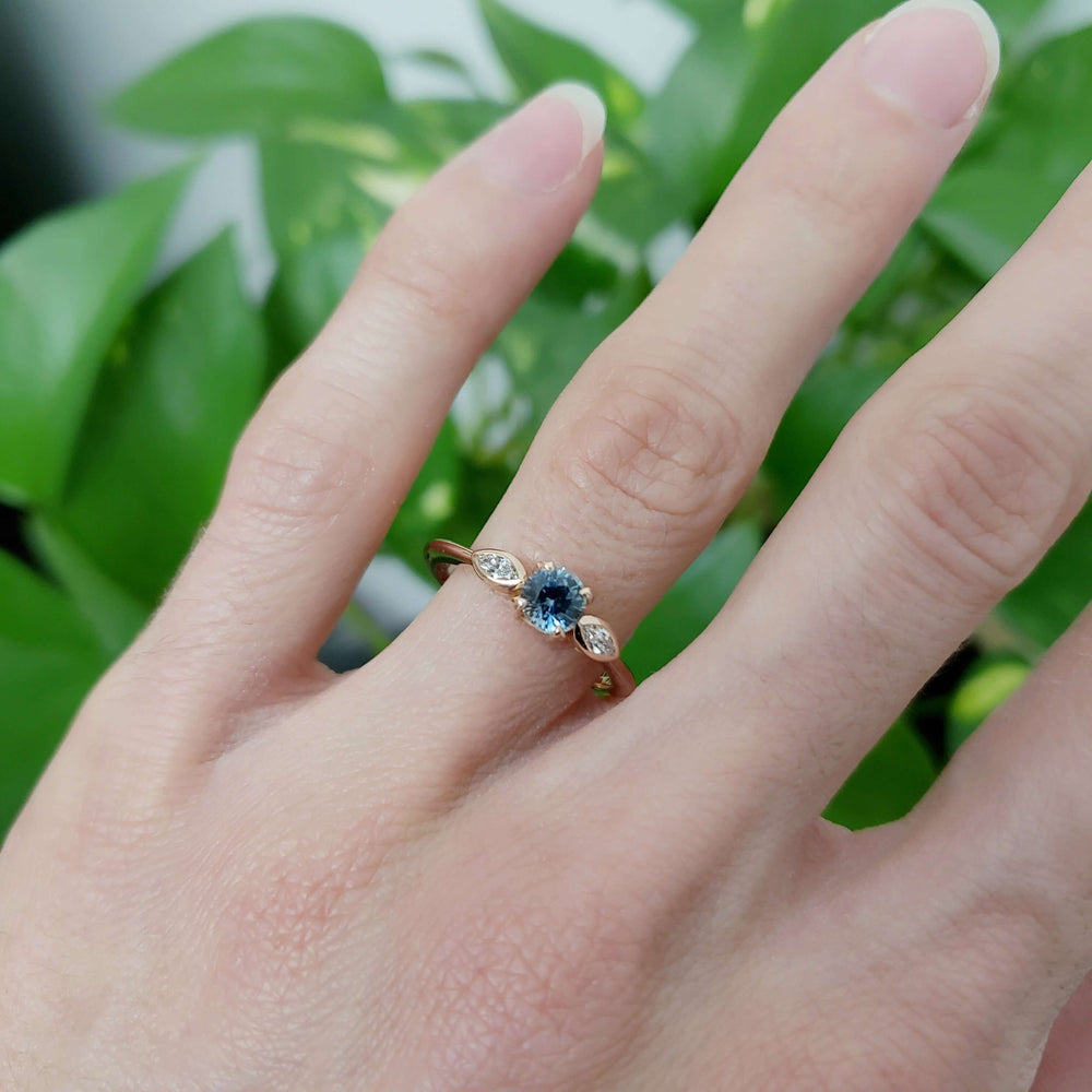 Montana sapphire and marquise diamond rose gold ring worn on hand