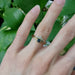 Montana sapphire and yellow gold ring stacked with two bands, worn on hand