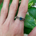 Montana sapphire engagement ring stacked with chevron and engraved bands on hand