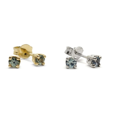 Pair of Montana sapphire stud earrings in 14kt yellow and white gold with teal round sapphires