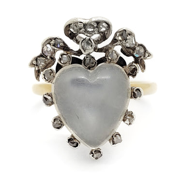 Heart-shaped moonstone ring with diamond accents on a white background
