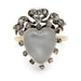 Heart-shaped moonstone ring with diamond accents on a white background