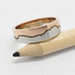 Mountain range wedding band in 14k white and rose gold displayed on a pencil
