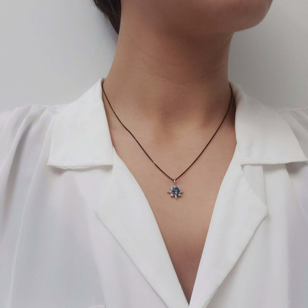 North Star pendant with blue Montana sapphire and lab diamonds worn on a model