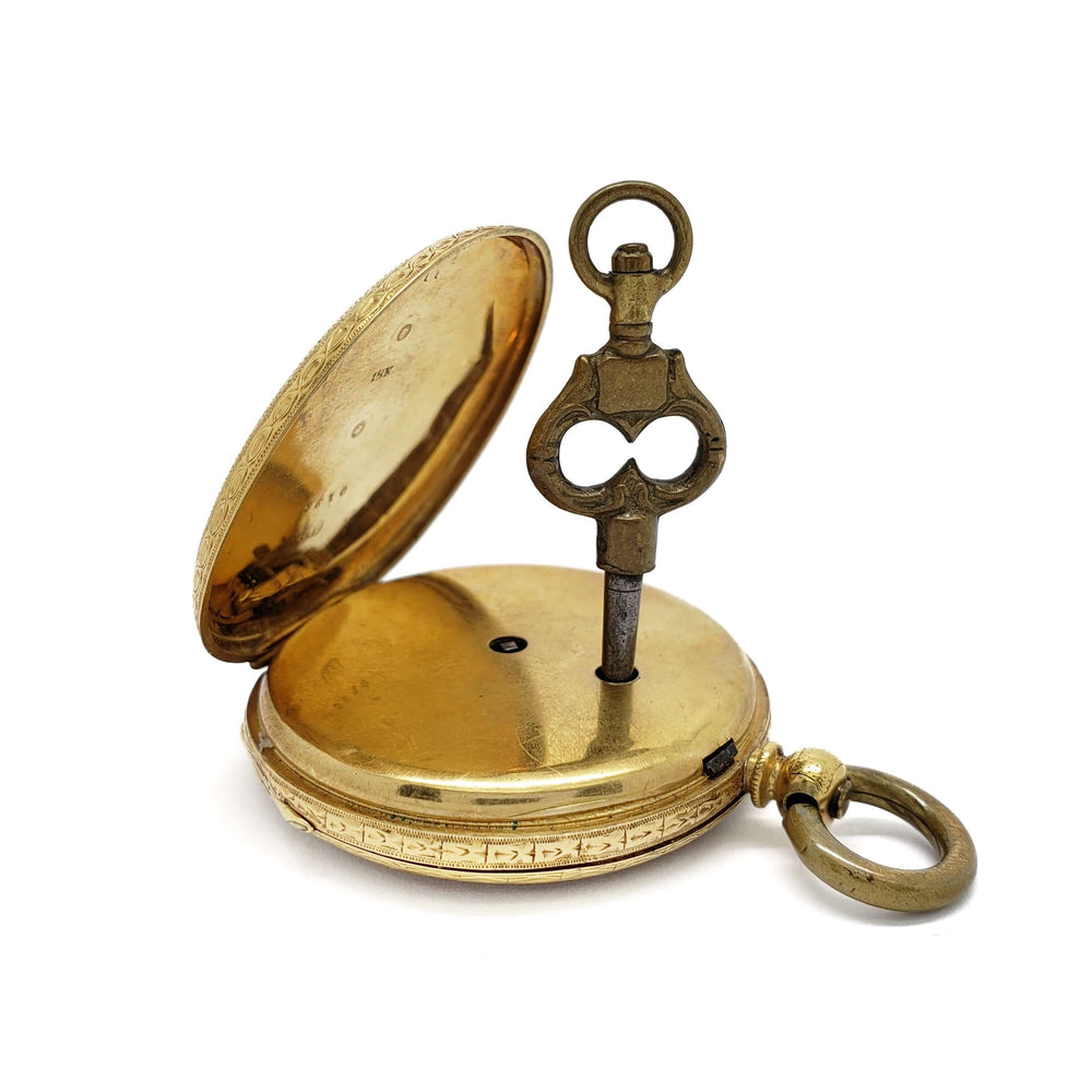 Open antique 18kt yellow gold pocket watch with original winding key inserted