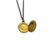 Open antique gold-toned round locket showing inside compartments