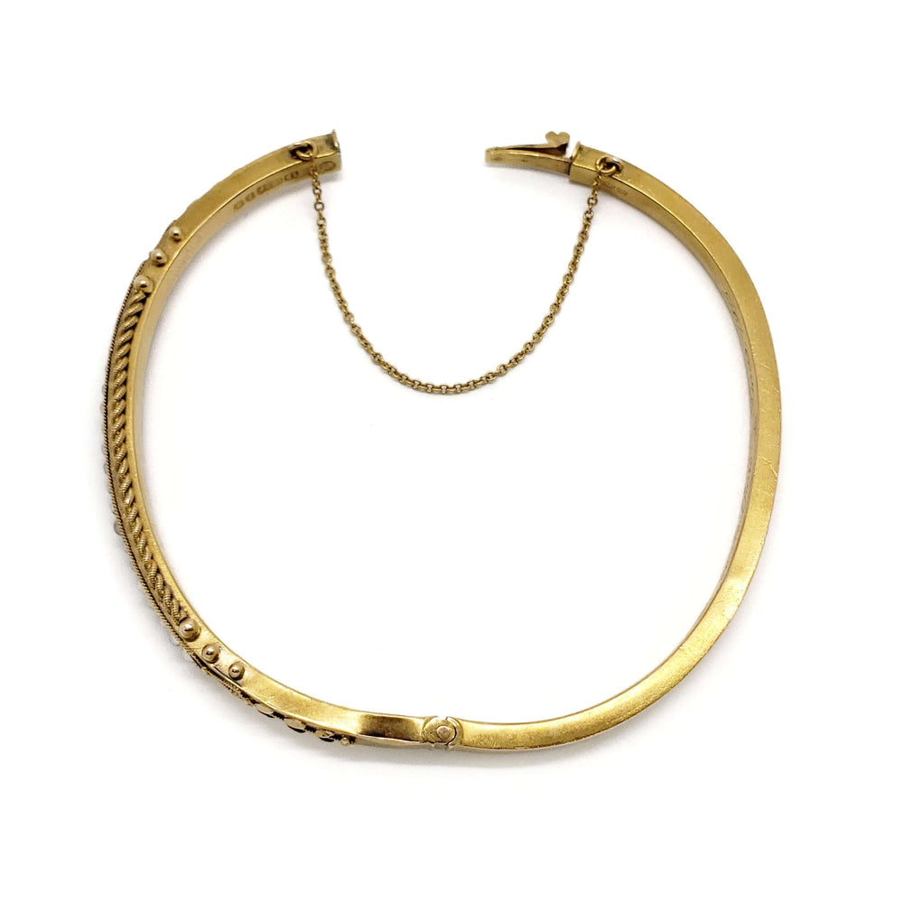 Antique 15kt yellow gold bangle with seed pearls shown open with safety chain