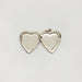 Open vintage sterling silver heart locket with empty photo compartments