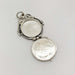 Open vintage sterling silver round locket showing interior