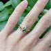 Oriana 14kt yellow gold marquise lab diamond ring stacked with a leaf band on a hand