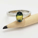 Oval bi-colour Australian sapphire ring in white gold displayed on a pencil