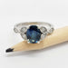 Oval blue sapphire and diamond ring in 14K white gold, shown with a pencil for scale