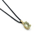 Oval green beryl pendant in 14kt yellow gold on a black chain, close-up view